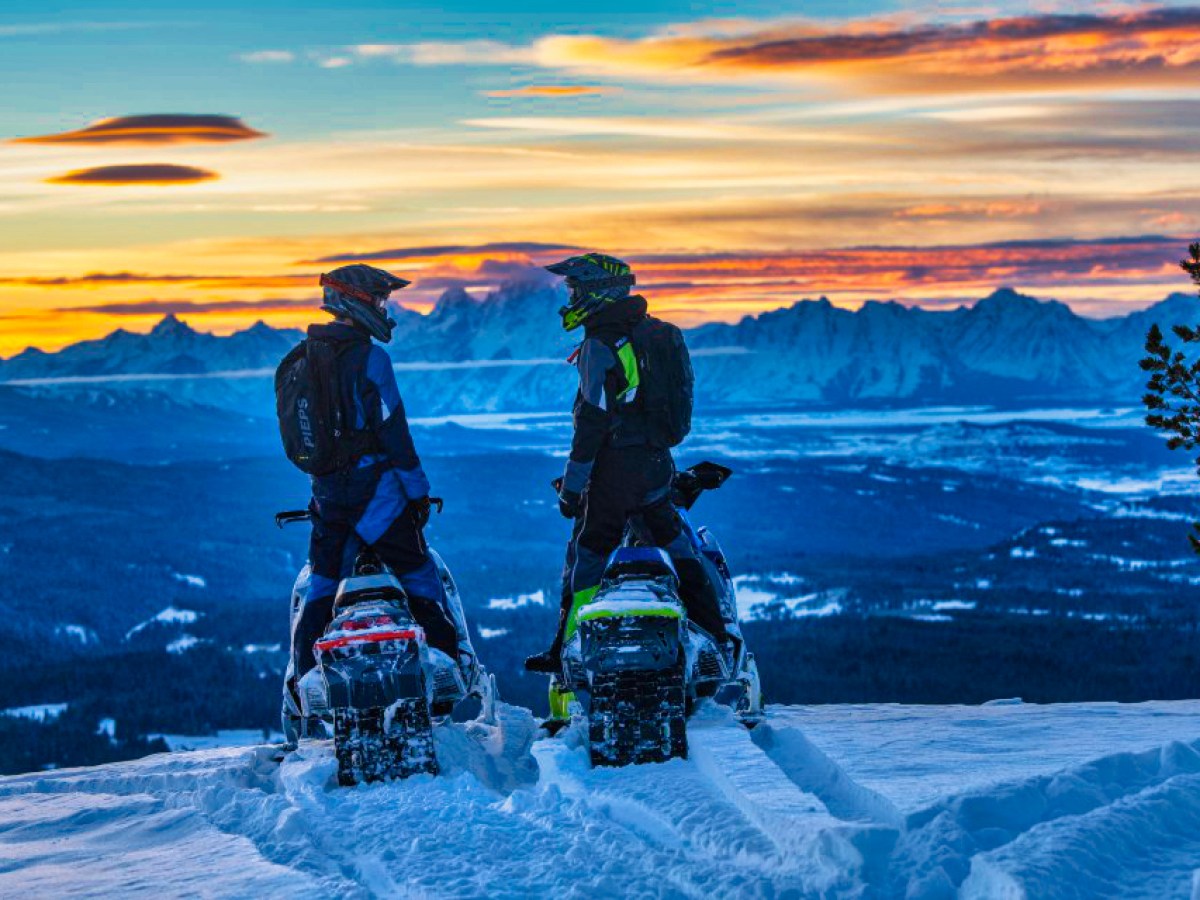 a couple of people that are standing in the snow