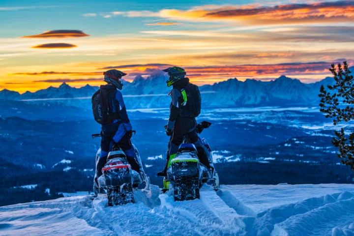 a couple of people that are standing in the snow
