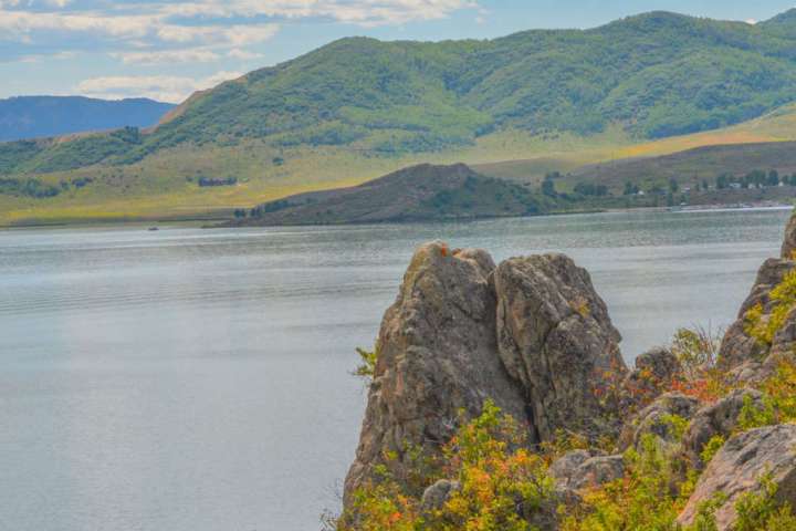 a body of water with a mountain in the background