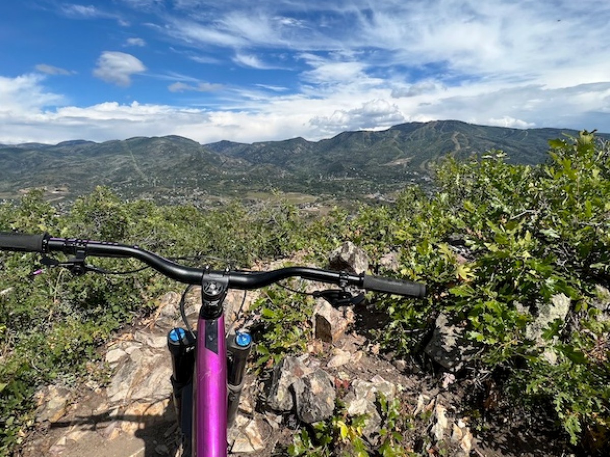 a person standing in front of a mountain